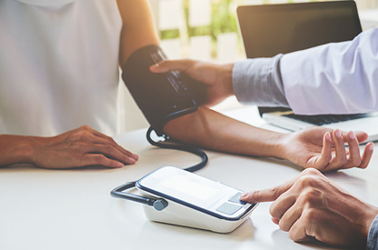 A doctor taking someone's blood pressure